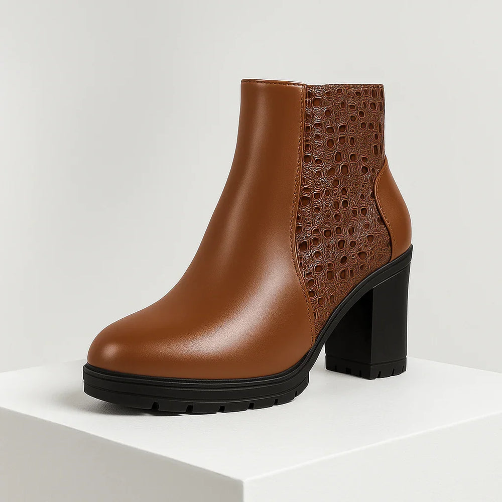 Brown ankle boot with perforated design on a white background