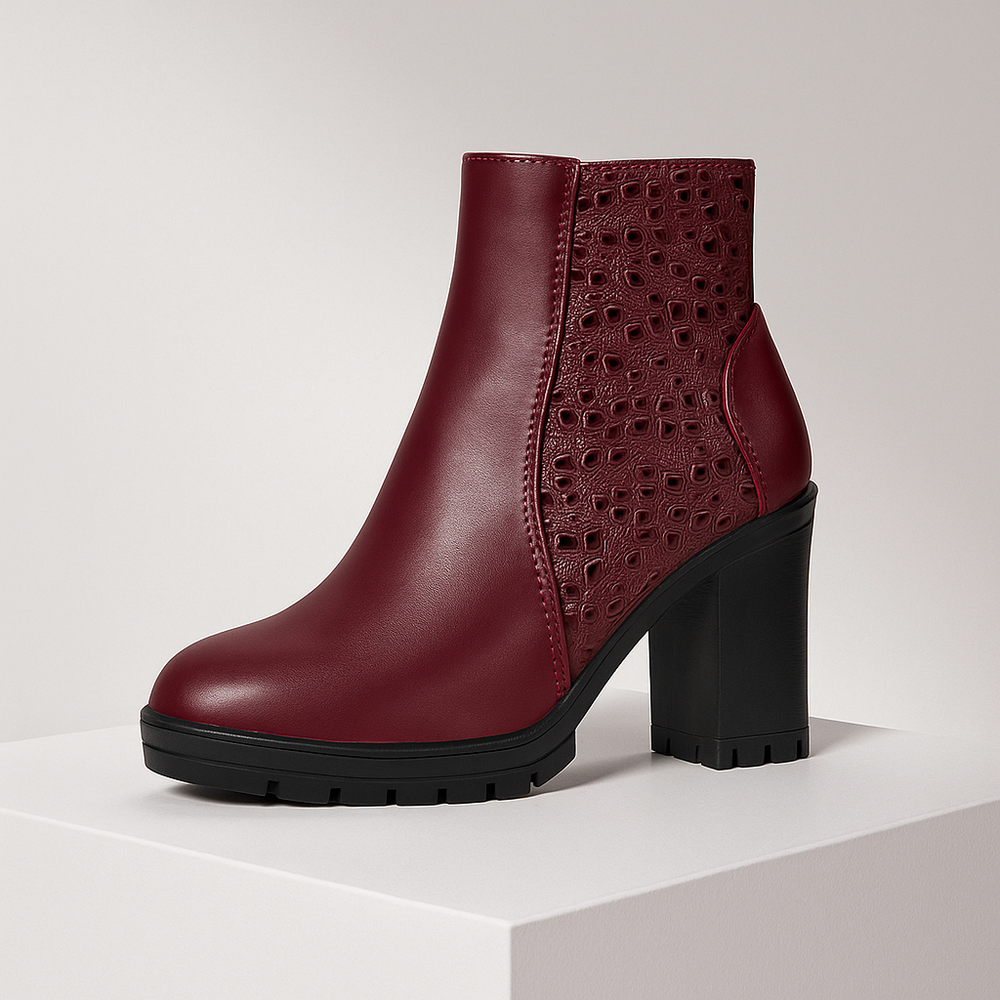 Maroon ankle boot with black sole on a light gray background