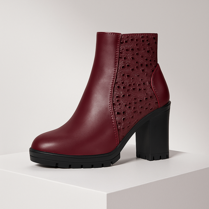 Maroon ankle boot with black sole on a light gray background